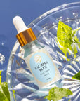 Kaia Skin Calming Blue Face Oil with Blue Tansy, Jasmine flowers, and olive squalane in a serene ritual setting