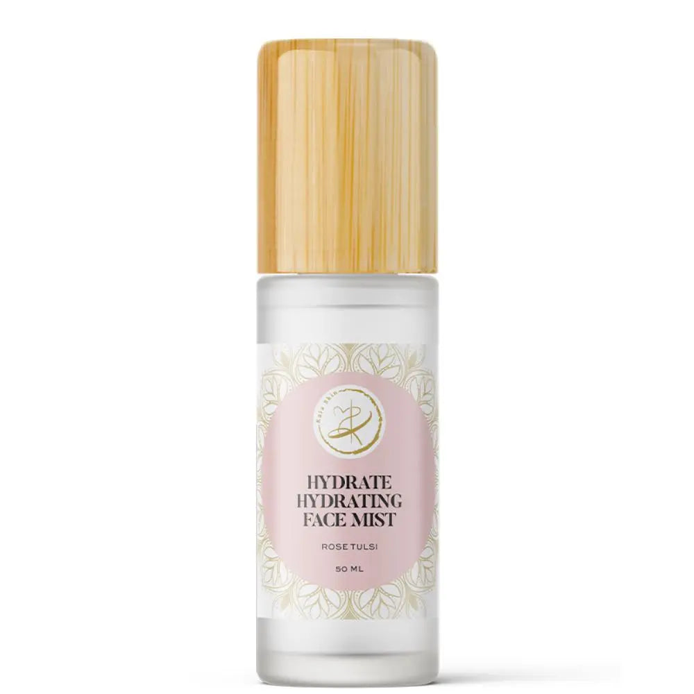 Kaia Skin Rose Tulsi Hydrate hydrosol mist with fresh rose petals and tulsi leaves in a ritual setting