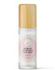 Kaia Skin Rose Tulsi Hydrate hydrosol mist with fresh rose petals and tulsi leaves in a ritual setting