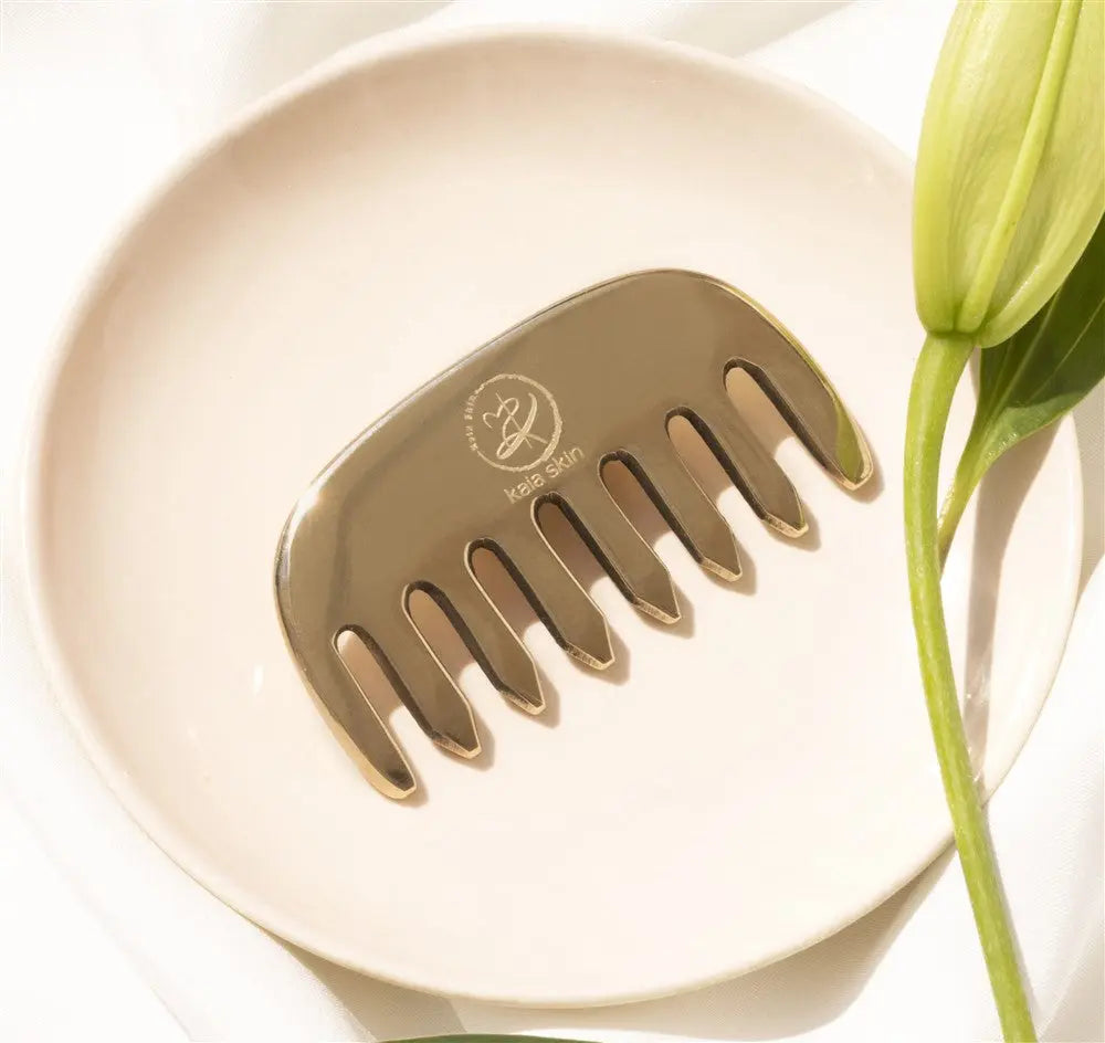 Kaia Skin Kansa Comb with Ayurvedic Intensive Hair Drops in a serene scalp-massage ritual setup